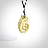 This is a unique manaia with koru, hand carved natural bone pendant with Paua Shell eyes. The cord is Black and is length adjustable. This is delivered to you with Express Courier. The eyes are made from Paua shell.